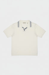 White cotton polo shirt featuring navy stripes on the collar, tailored fit.